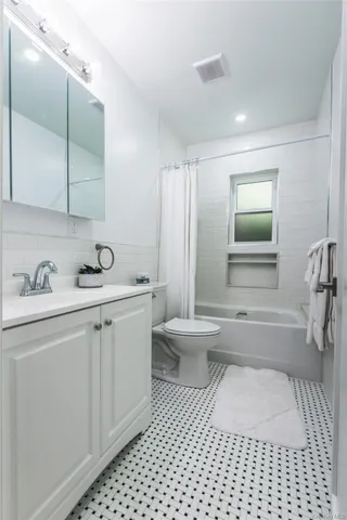 a bedroom with a bed and a potted plant