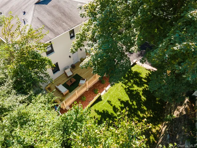 an aerial view of a house with a yard