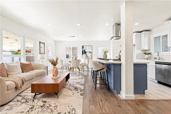 a living room with lots of furniture and kitchen view