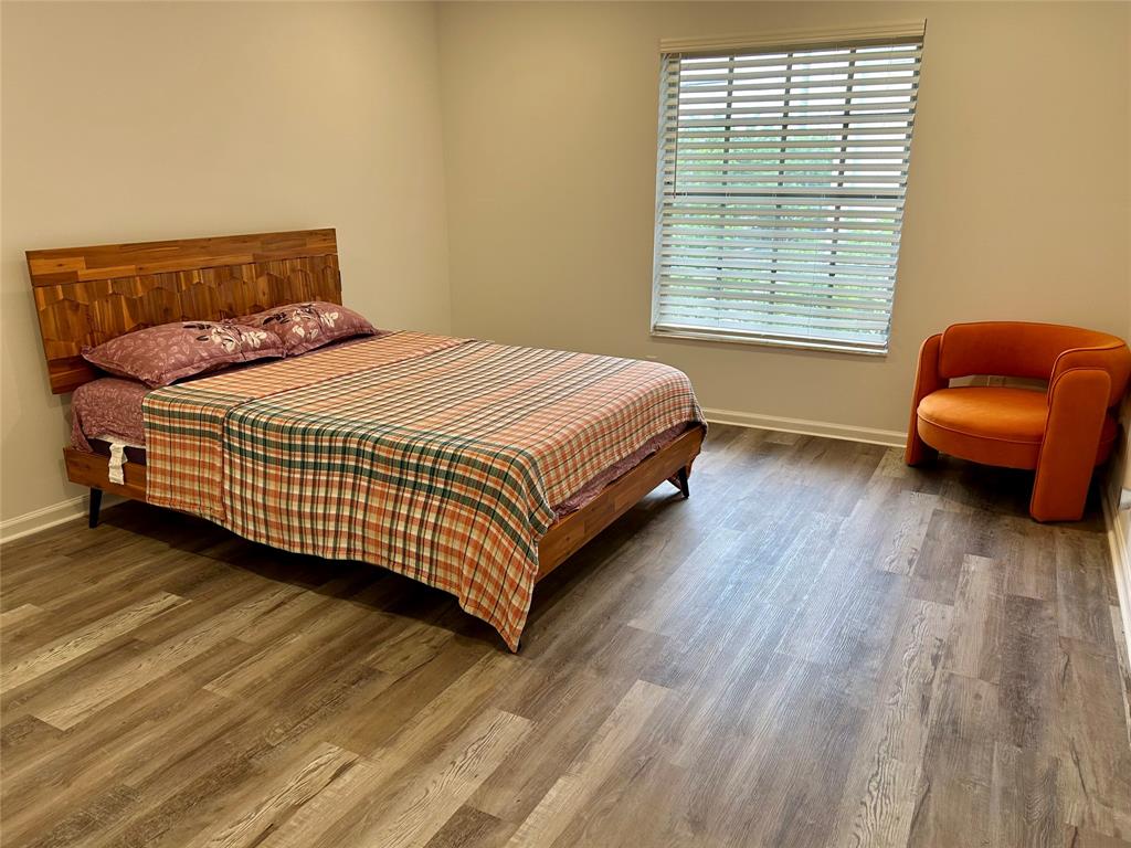 2151 Northeast 68th Street, Unit 226 Fort Lauderdale, FL 33308 - Photo 11 of 49 a bedroom with a bed and a chair