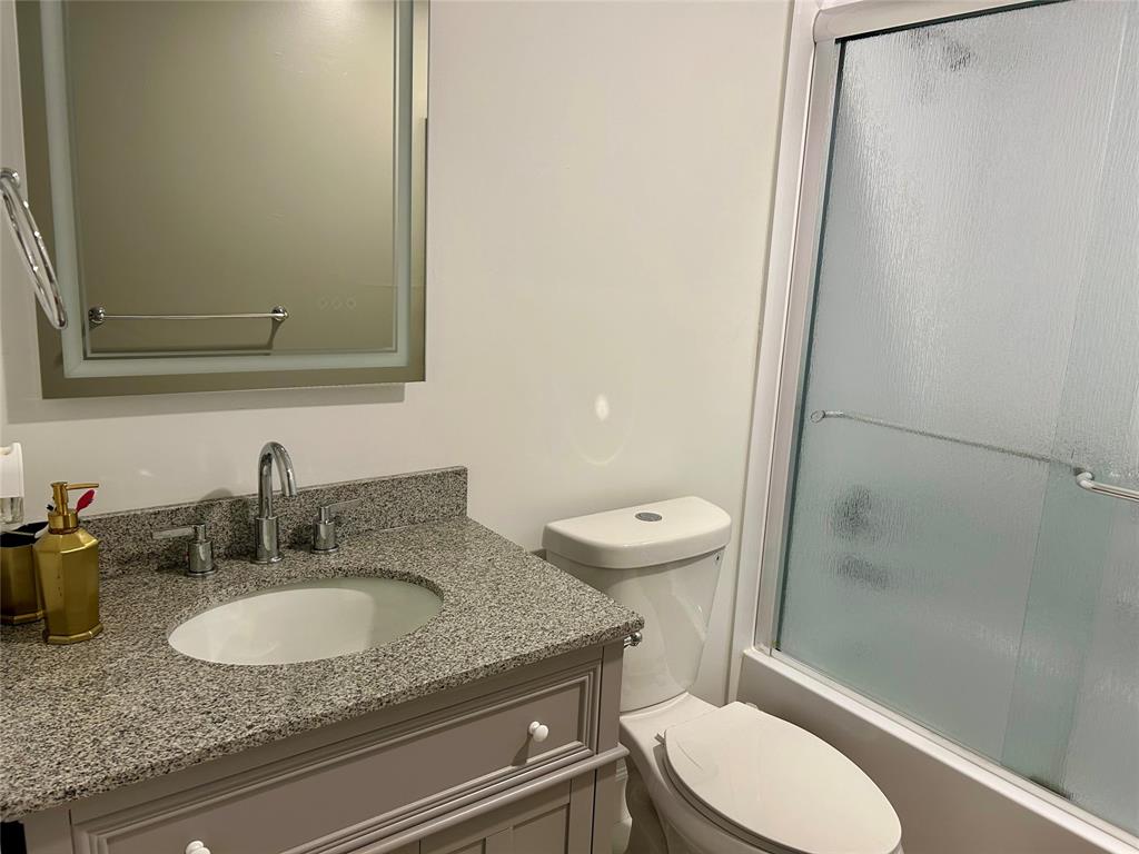 2151 Northeast 68th Street, Unit 226 Fort Lauderdale, FL 33308 - Photo 16 of 49 a bathroom with a granite countertop sink toilet and shower