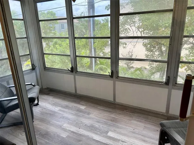 a view of a room with wooden floor and chair