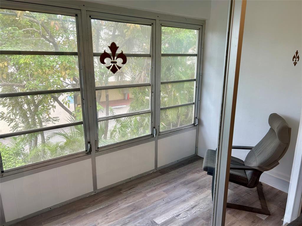 2151 Northeast 68th Street, Unit 226 Fort Lauderdale, FL 33308 - Photo 19 of 49 a view of a room with wooden floor and windows