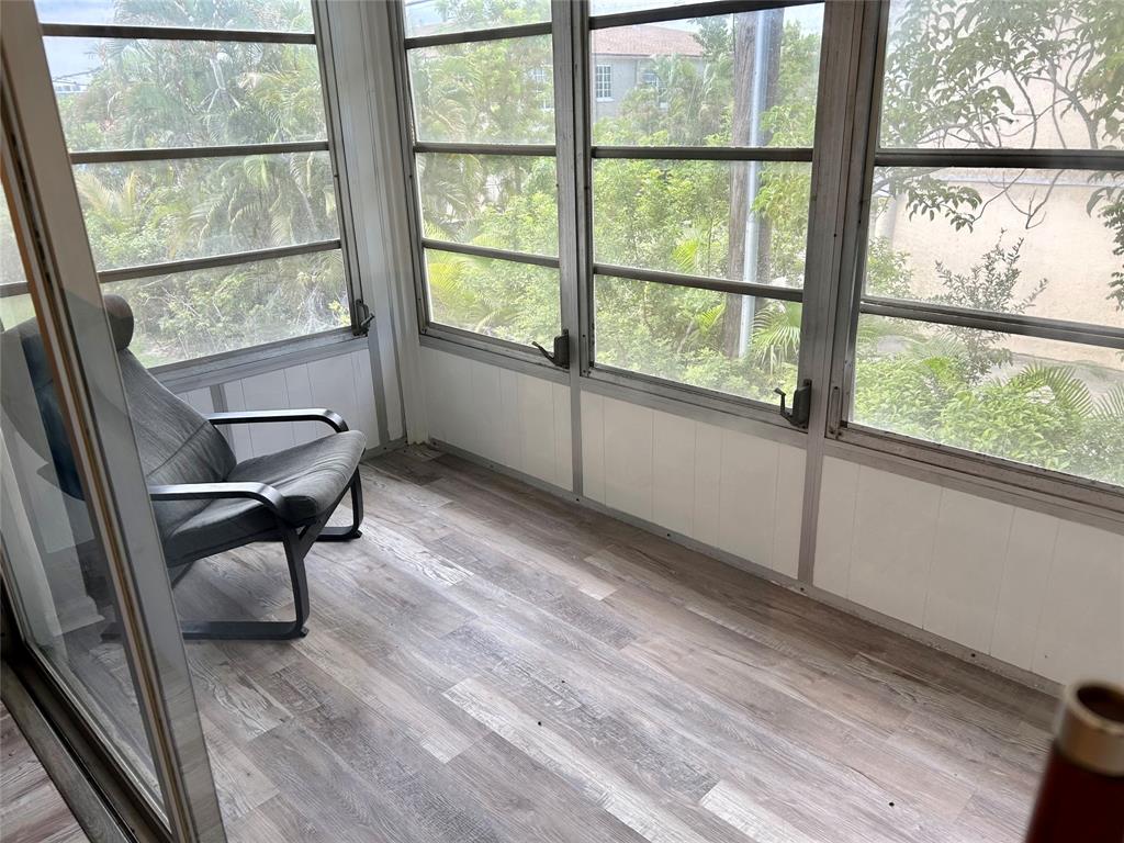 2151 Northeast 68th Street, Unit 226 Fort Lauderdale, FL 33308 - Photo 20 of 49 a view of a room with wooden floor and chair