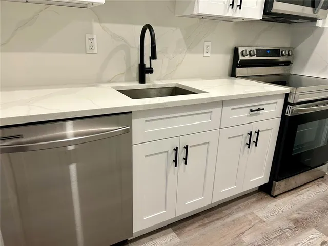 a close view of sink and cabinets
