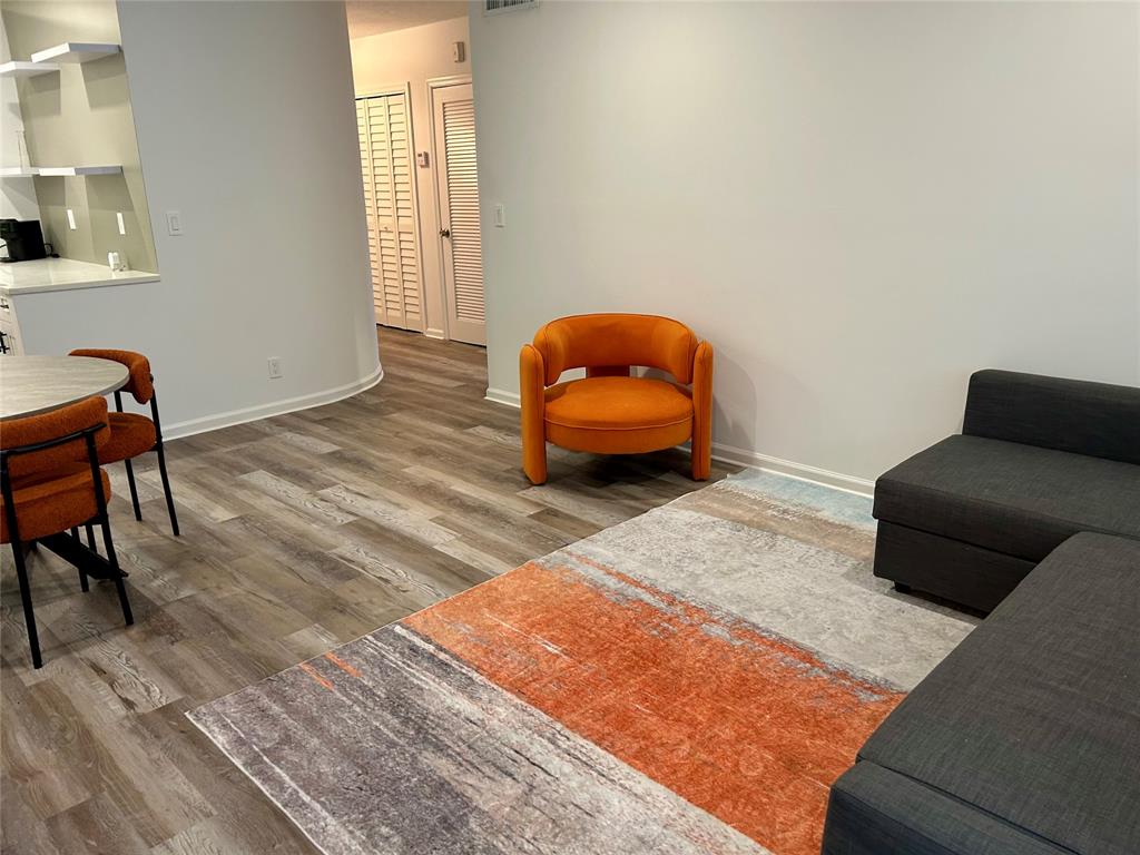 2151 Northeast 68th Street, Unit 226 Fort Lauderdale, FL 33308 - Photo 25 of 49 a living room with furniture and a wooden floor