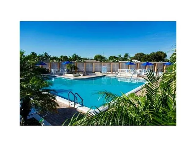 a view of a swimming pool with lounge chairs