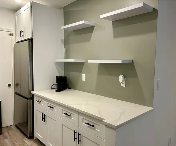 a kitchen with a sink stove and refrigerator