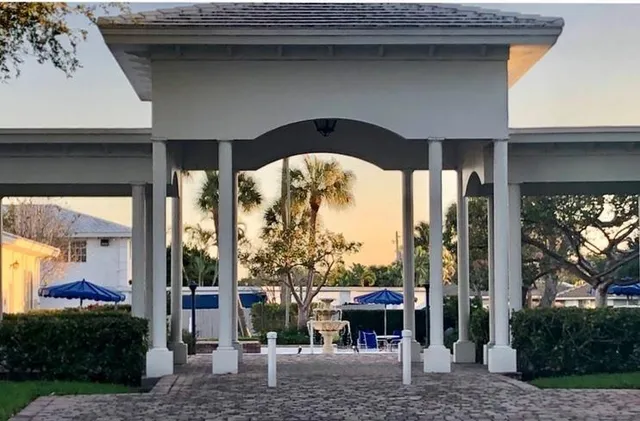 a view of a house with backyard and porch