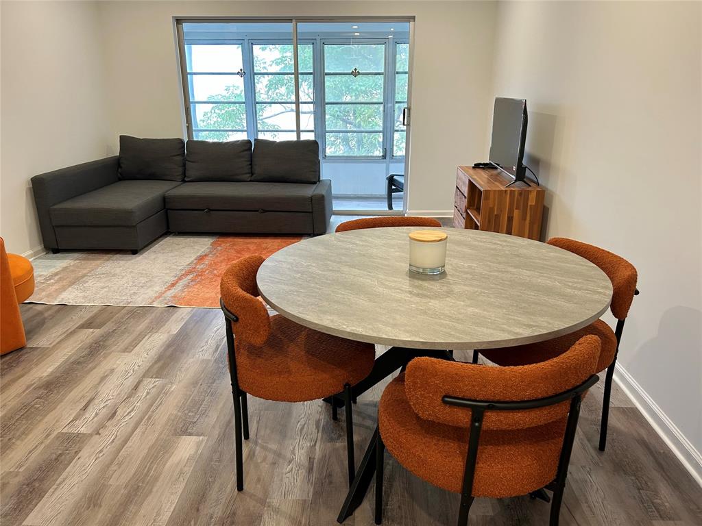 2151 Northeast 68th Street, Unit 226 Fort Lauderdale, FL 33308 - Photo 4 of 49 a living room with furniture and wooden floor