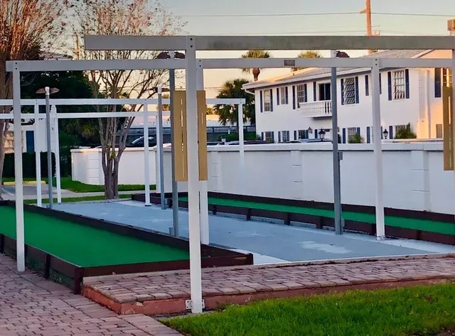 front view of a white house with a tree
