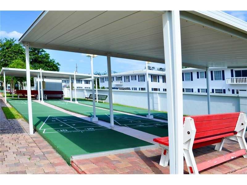 2151 Northeast 68th Street, Unit 226 Fort Lauderdale, FL 33308 - Photo 45 of 49 a view of a chair and table on the patio
