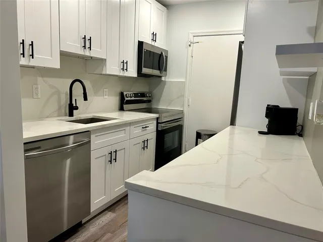a kitchen with a sink stove and refrigerator