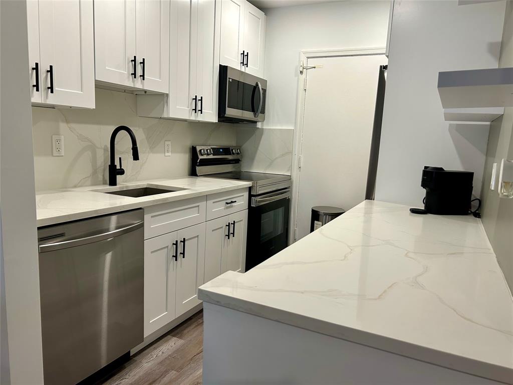 2151 Northeast 68th Street, Unit 226 Fort Lauderdale, FL 33308 - Photo 6 of 49 a kitchen with a sink a stove and refrigerator