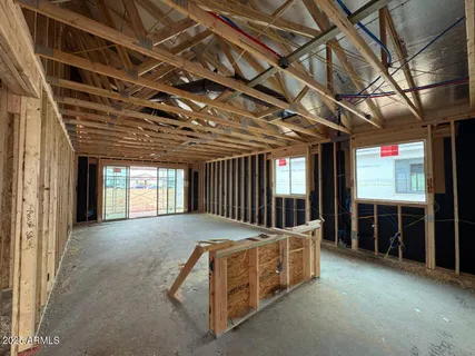 a view of an empty room with furniture and windows