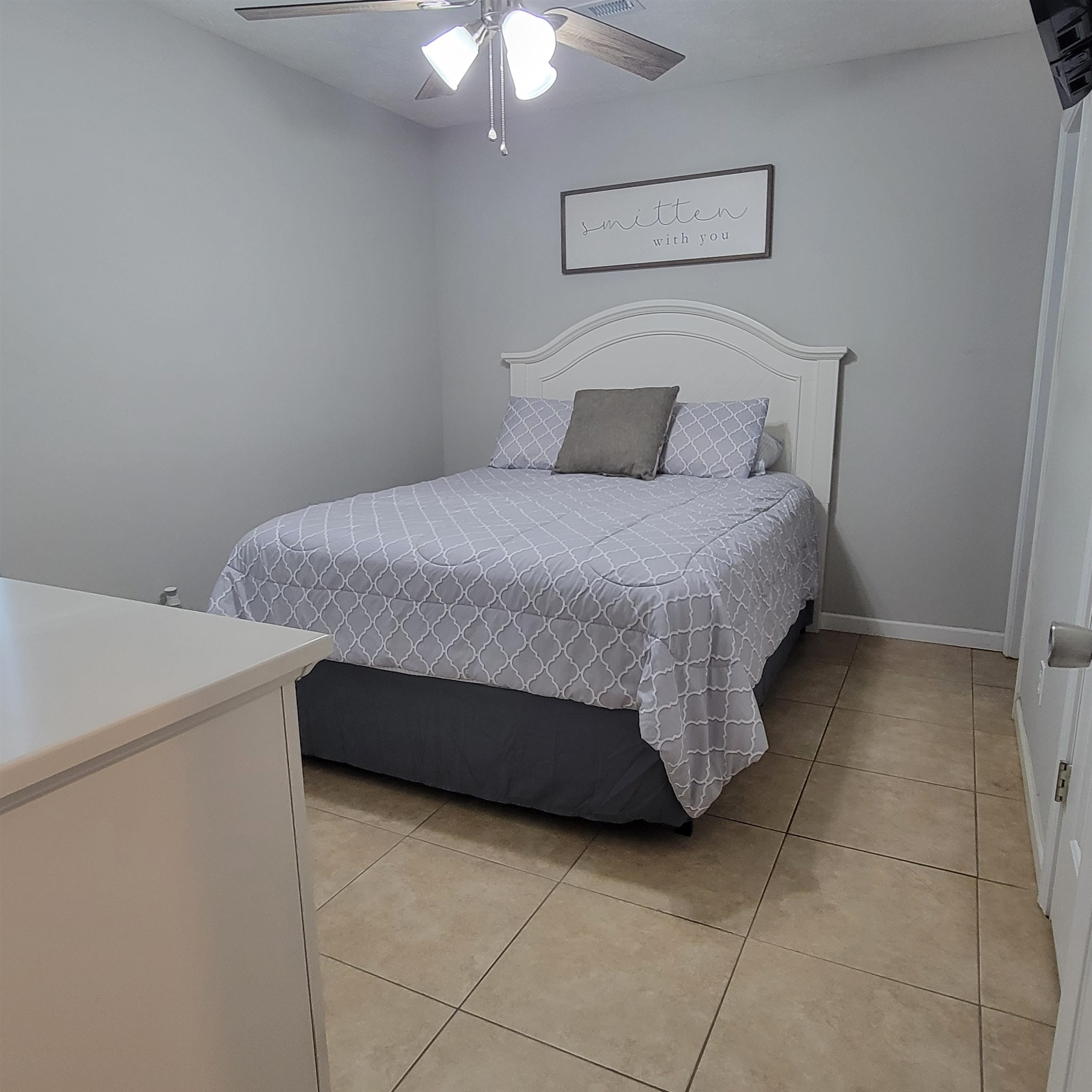 3106 Riverside Drive Jackson, TN 38301 - Photo 11 of 19 a bedroom with a bed and a chandelier