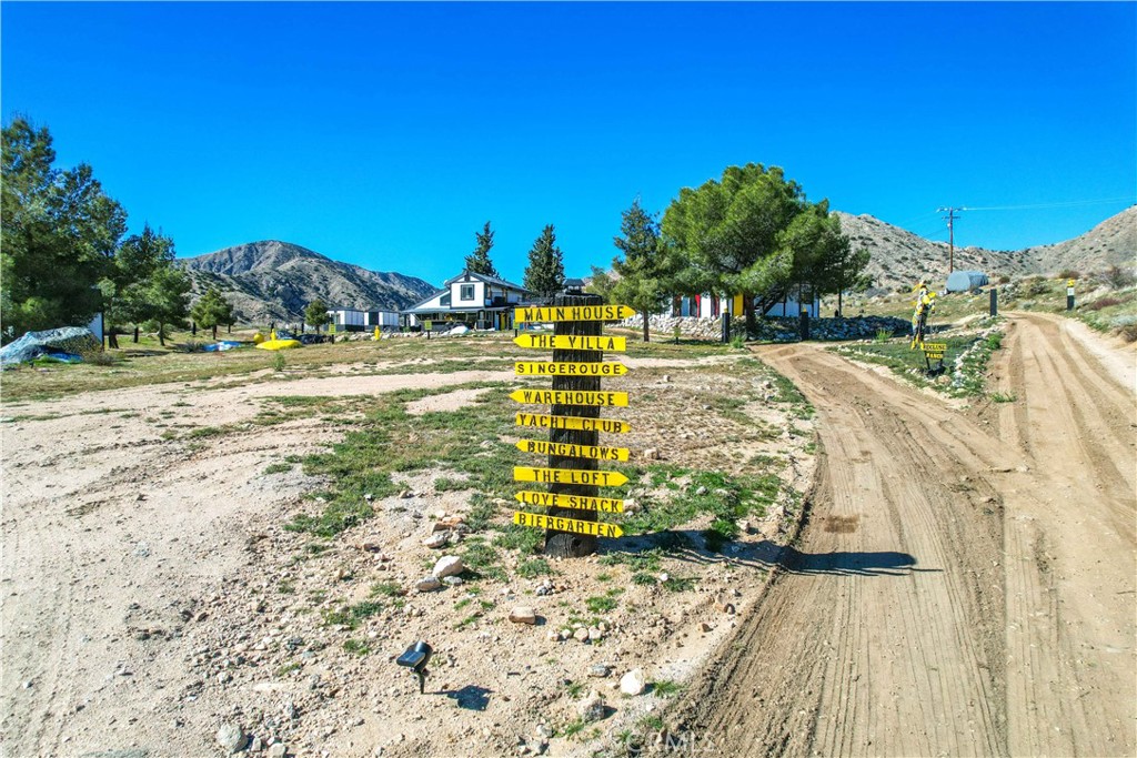 49490 Big Morongo Canyon Road Morongo Valley, CA 92256 - Photo 66 of 75 a front view of a house with a yard