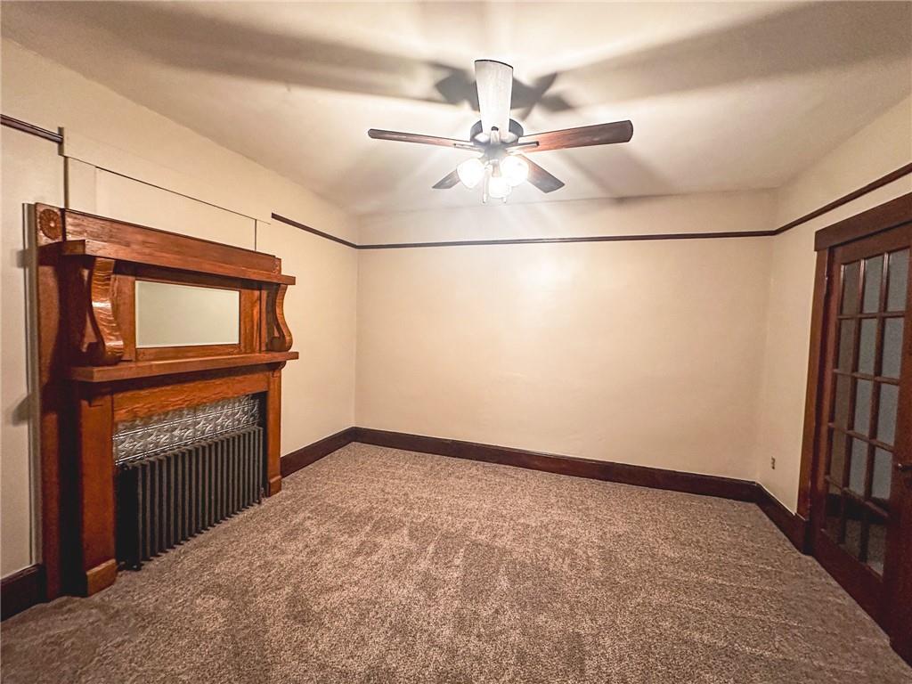 276 13th Street, Unit 1 Ambridge, PA 15003 - Photo 16 of 17 a view of a livingroom with a fireplace a ceiling fan and wooden floor