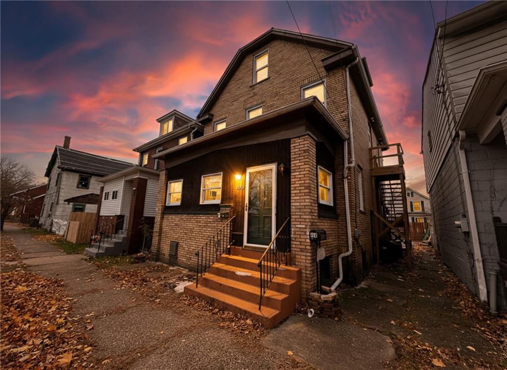 276 13th Street, Unit 1 Ambridge, PA 15003 - Photo 2 of 17 a view of a house with a large window and wooden fence