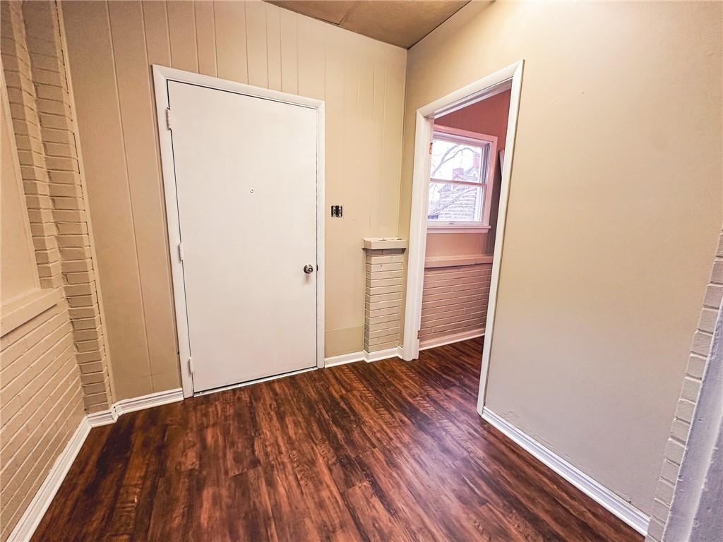 276 13th Street, Unit 1 Ambridge, PA 15003 - Photo 4 of 17 an empty room with wooden floor and entrance