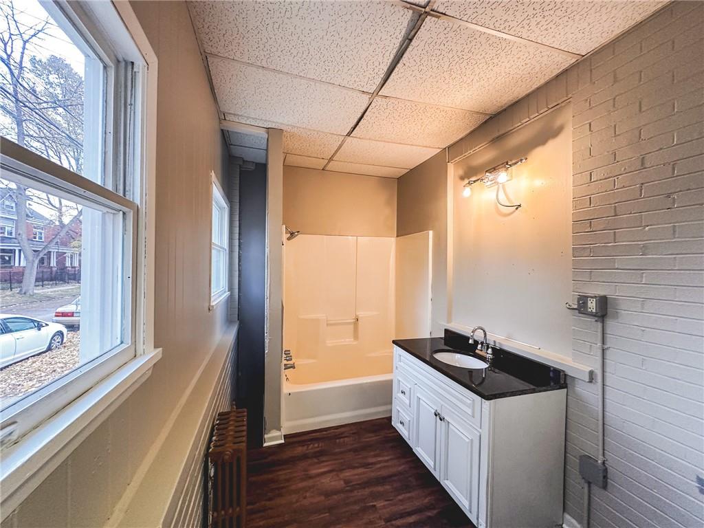 276 13th Street, Unit 1 Ambridge, PA 15003 - Photo 5 of 17 a kitchen with granite countertop a sink and a large window