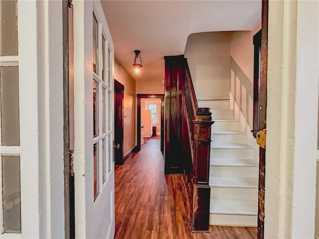276 13th Street, Unit 1 Ambridge, PA 15003 - Photo 6 of 17 a view of hallway with wooden floor and stairs