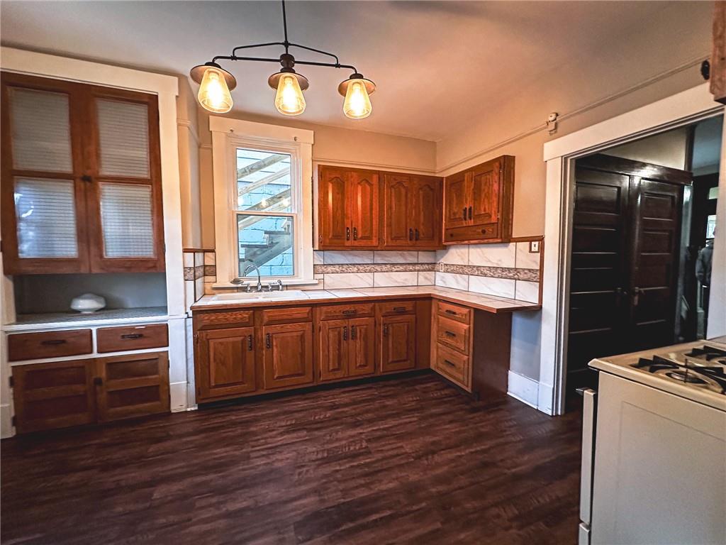 276 13th Street, Unit 1 Ambridge, PA 15003 - Photo 7 of 17 a kitchen with stainless steel appliances kitchen island wooden cabinets and a counter top