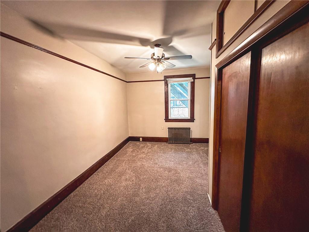 276 13th Street, Unit 1 Ambridge, PA 15003 - Photo 10 of 17 an empty room with windows and fan