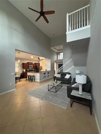 a living room with furniture a rug and white walls