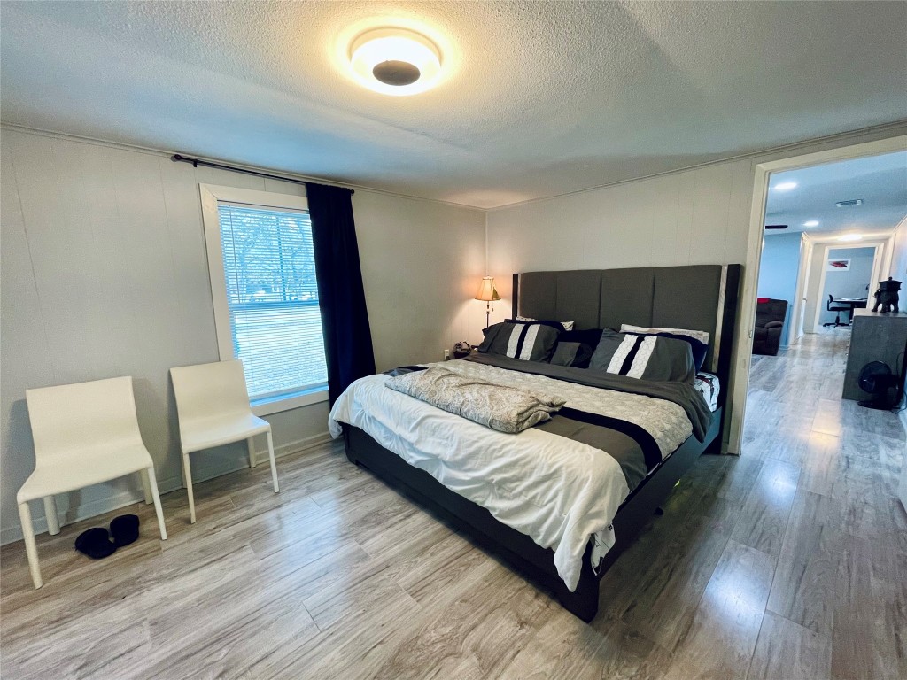 2504 Davisville Road Lufkin, TX 75901 - Photo 13 of 26 a bedroom with a bed and a chair