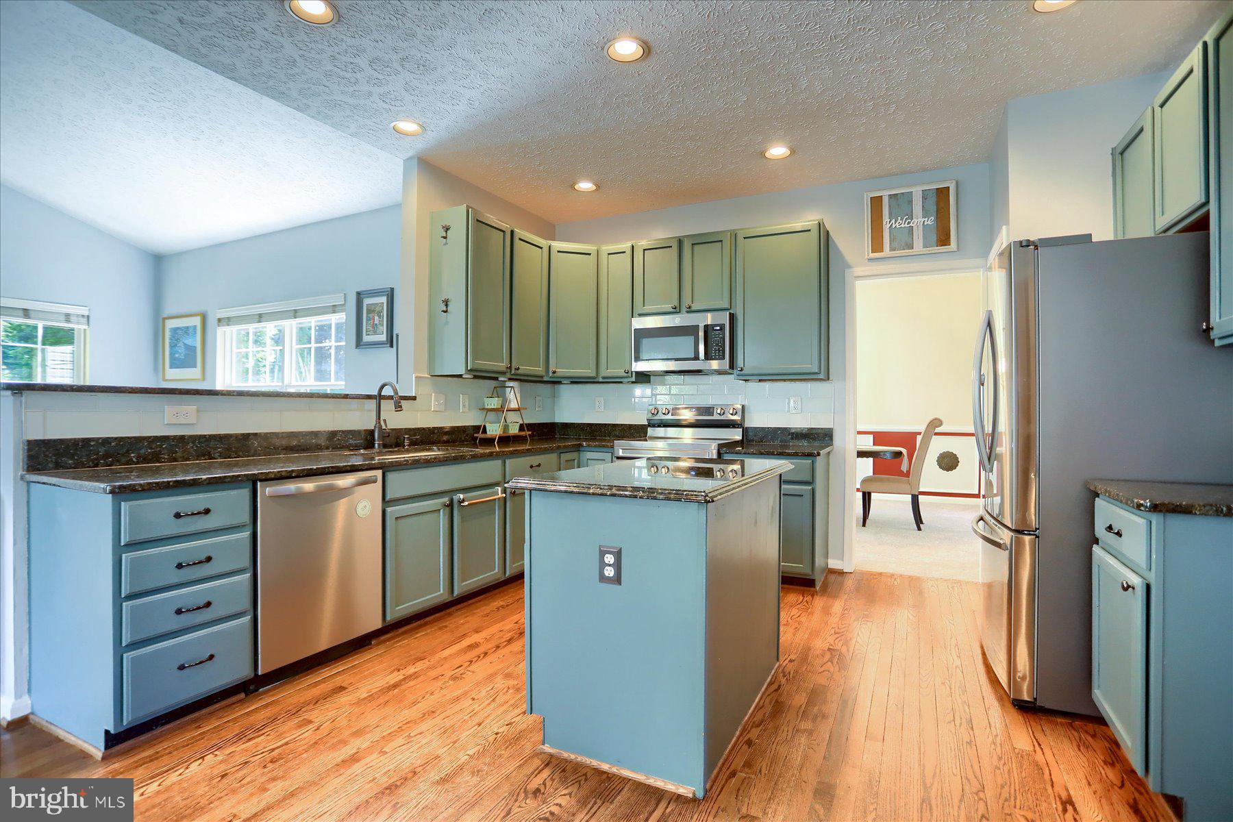 631 Prestwick Trail Bel Air, MD 21014 - Photo 12 of 64 a kitchen with stainless steel appliances granite countertop a refrigerator a stove and a sink