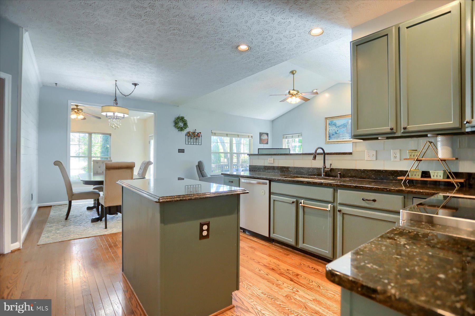631 Prestwick Trail Bel Air, MD 21014 - Photo 13 of 64 a kitchen with granite countertop a sink stove and cabinets
