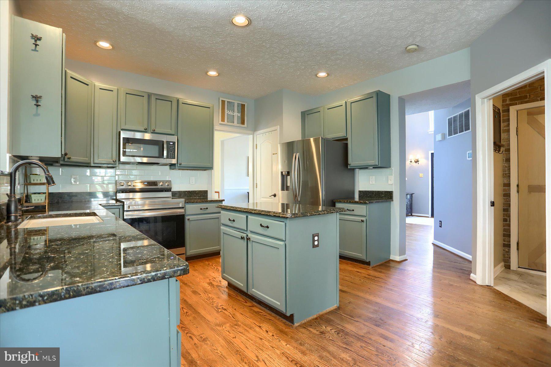 631 Prestwick Trail Bel Air, MD 21014 - Photo 10 of 64 a kitchen with stainless steel appliances granite countertop a refrigerator stove and sink
