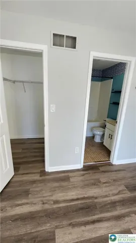 a view of entryway and hall with wooden floor