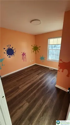 wooden floor in a hall with a window