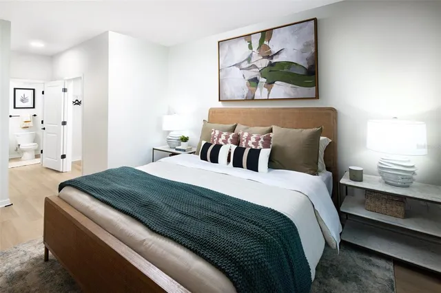 a bedroom with bed and painting on the wall