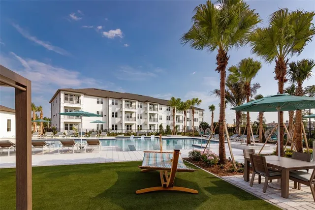 a swimming pool view with a outdoor seating