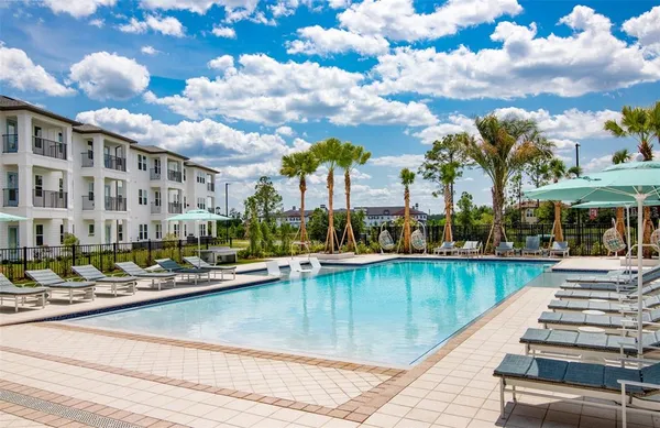 a view of a swimming pool with outdoor seating