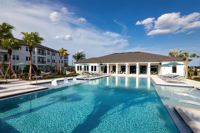 a front view of a house with swimming pool having outdoor seating