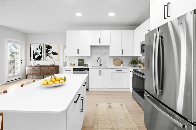 a kitchen with a sink refrigerator and window