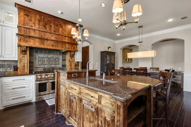 a kitchen with center island wooden floor dining table and chairs