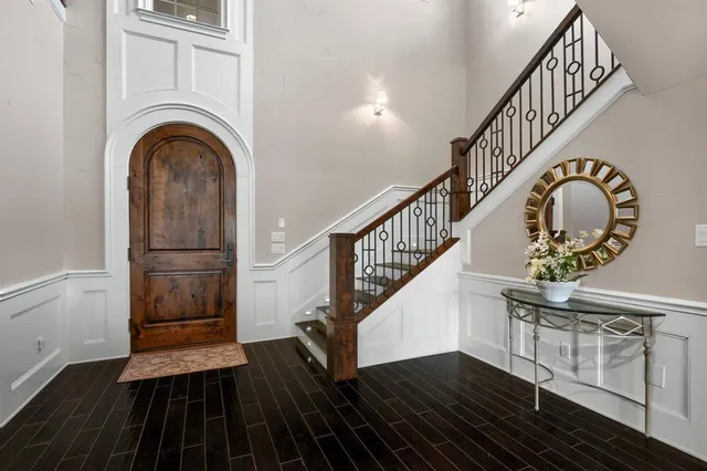 a view of entryway and hall with wooden floor