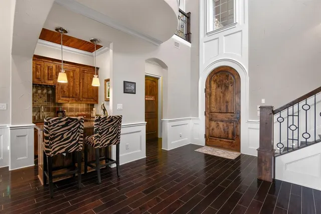 a dining room with furniture entryway and wooden floor