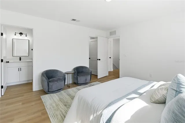 a bedroom with a bed and a chair