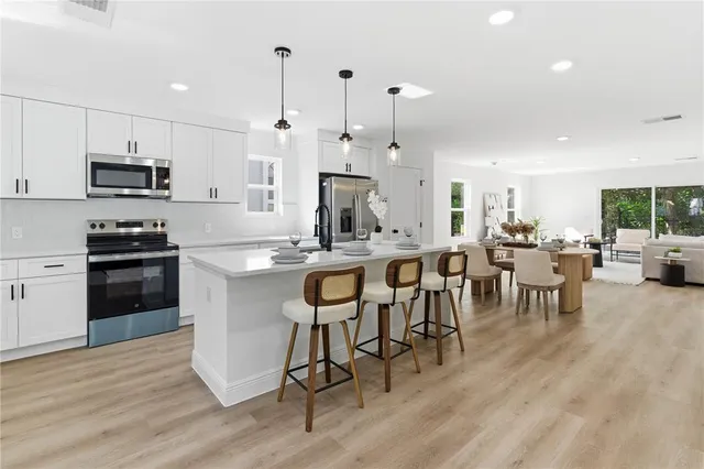 a large kitchen with a table and chairs