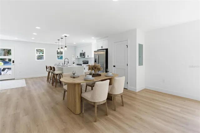 a view of a dining room with furniture and wooden floor