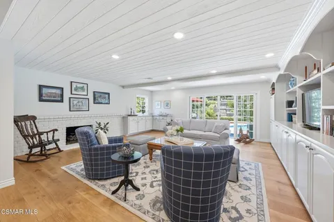 a living room with furniture a rug and a table