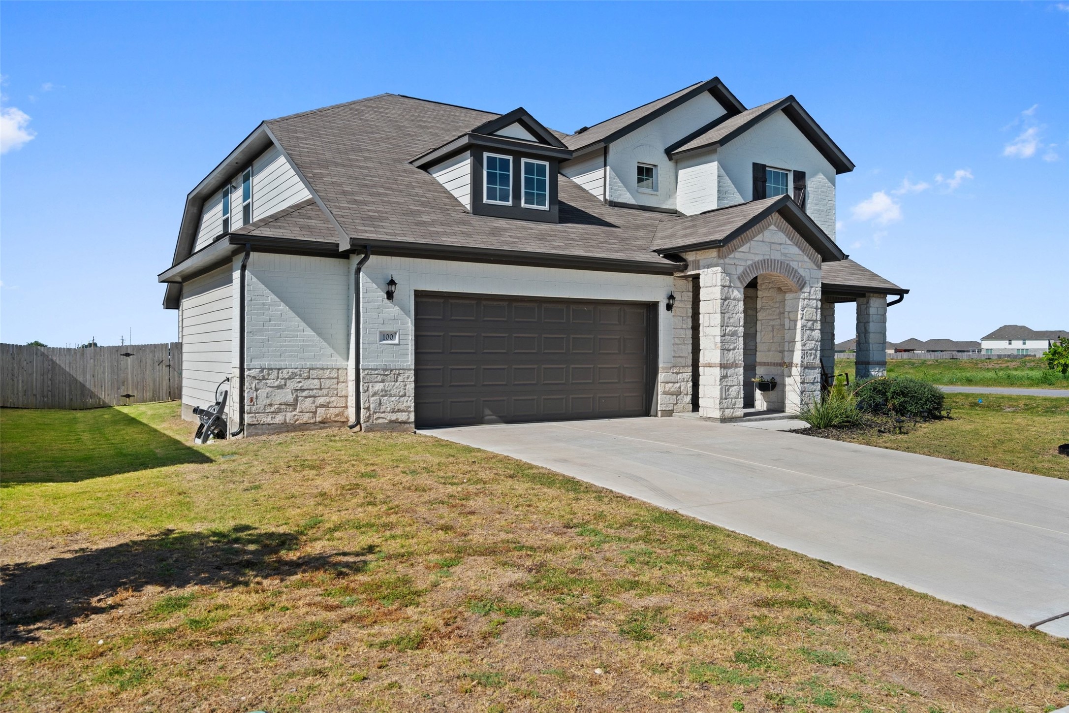 100 Panico Road Hutto, TX 78634 - Photo 2 of 28 A charming two-story home with a durable shingle roof and a spacious attached garage.