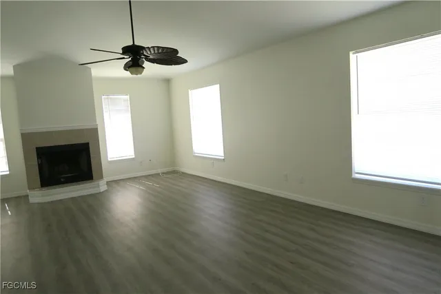 a kitchen with kitchen island a sink a stove a refrigerator and white cabinets
