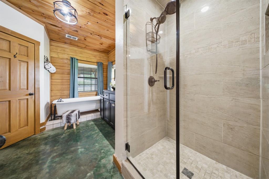 465 Emberson Ranch Road Pilot Point, TX 76258 - Photo 15 of 40 a bathroom with a tub and shower